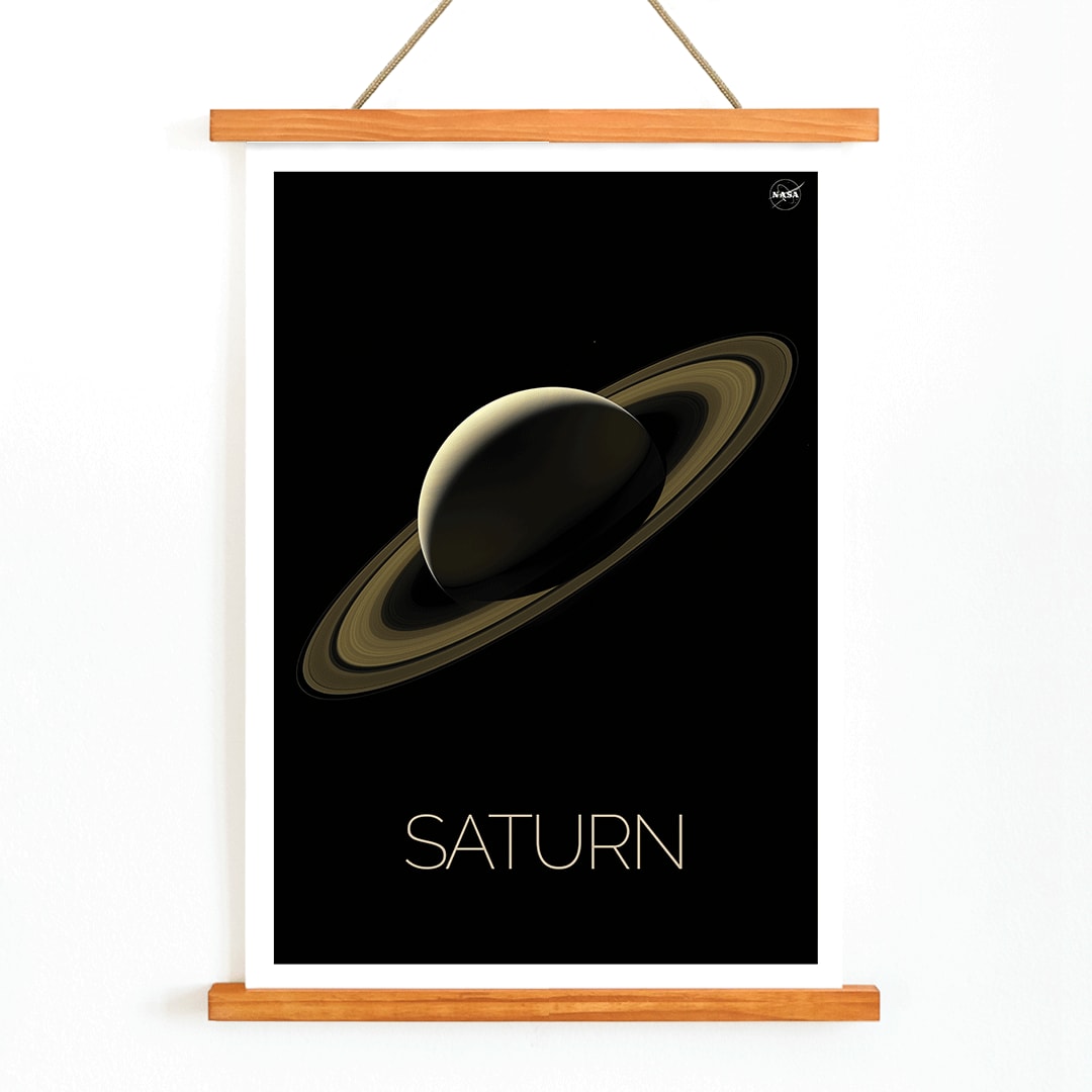 NASA illustration and poster of planet Saturn with rings against black background, with wooden magnetic frame on white background