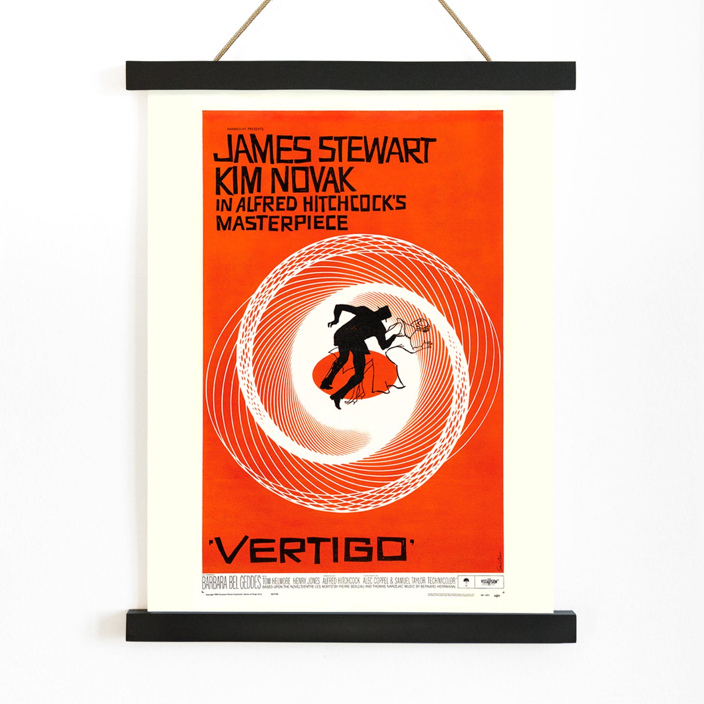 Vertigo movie poster by Saul Bass featuring vibrant orange background swirling spiral and silhouetted figures graphic design, with wooden magnetic frame on white background