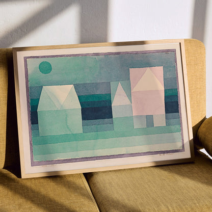 Abstract geometric houses in pastel green colors artwork by Paul Klee titled Three Houses poster featuring geometric house shapes, framed and displayed in modern living room decor