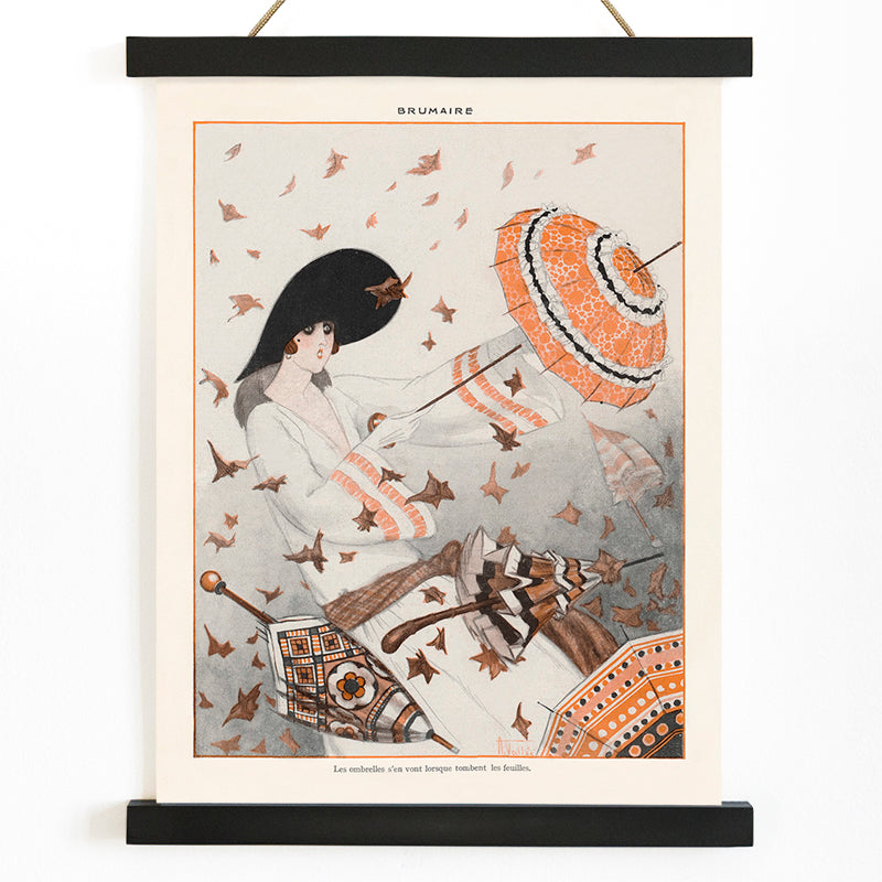 Brumaire by Armand Vallee poster featuring an elegant woman with a parasol surrounded by autumn leaves and wind, with wooden magnetic frame on white background