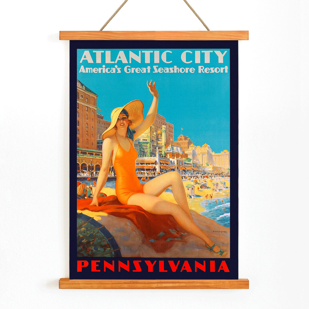Atlantic City beach scene and Pennsylvania Railroad poster by Edward M Eggleston featuring woman in orange swimsuit at beach resort, with wooden magnetic frame on white background