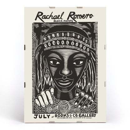 Black and white portrait block print poster with intricate patterns by Rachael Romero at Books and Co gallery, framed and displayed in modern living room decor
