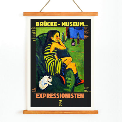 Brucke museum exhibition poster of Female Artist by Ernst Ludwig Kirchner showing a colorful expressionist scene, with wooden magnetic frame on white background