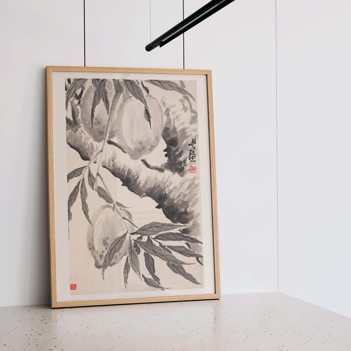 Chinese ink painting poster of peaches hanging from a branch in black ink wash style artwork by Min Zhen, framed and displayed in modern living room decor