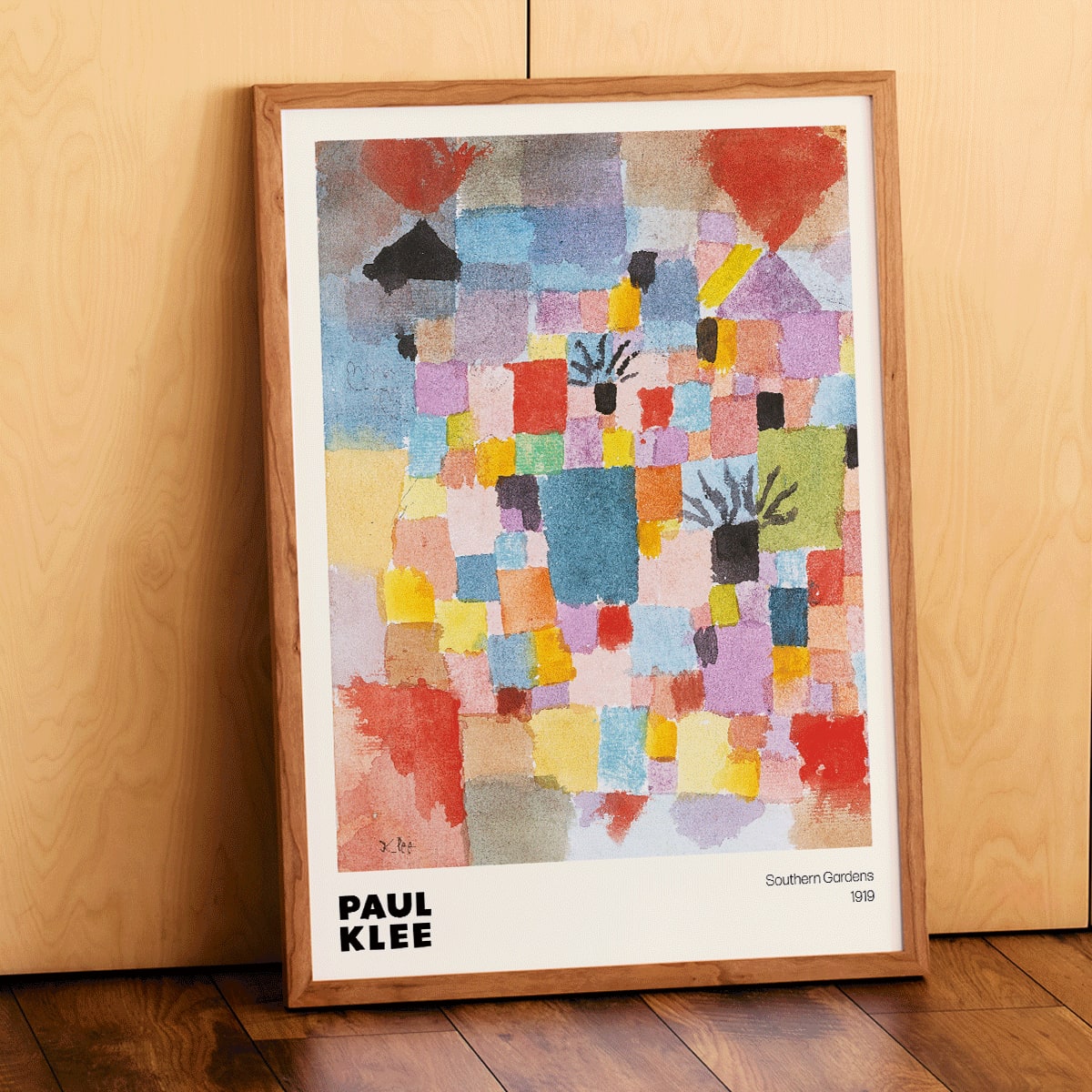 Colorful abstract painting Southern Gardens by Paul Klee featuring vibrant geometric blocks and shapes poster artwork, framed and displayed in modern living room decor