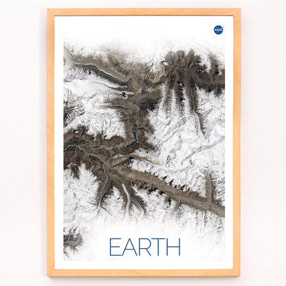 Stunning NASA satellite image of Earth showing snowy mountain ranges and rugged terrain high resolution poster, framed and displayed in modern living room decor