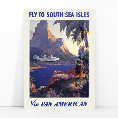 Vintage travel poster of a woman in a floral dress on a tropical island with a Pan American seaplane by Paul George Lawler, framed and displayed in modern living room decor