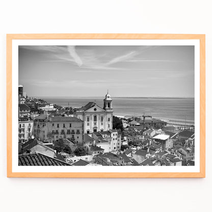 Lisbon Old City Landscape Black and White Picture 1 showing historic buildings rooftops and ocean view waterfront poster, framed and displayed in modern living room decor