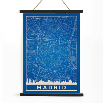 Minimalist Madrid Map by Artist Name blue and white city layout with silhouettes and street details poster, with wooden magnetic frame on white background