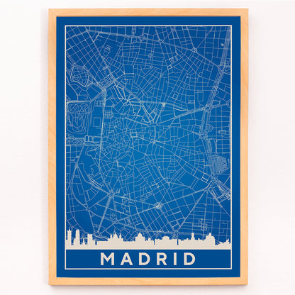 Minimalist Madrid Map by Artist Name blue and white city layout with silhouettes and street details poster, framed and displayed in modern living room decor