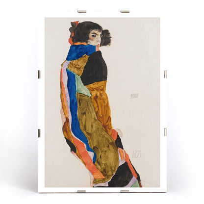 Colorful portrait poster of a woman in a patterned robe looking back Moa by Egon Schiele expressive art print, framed and displayed in modern living room decor