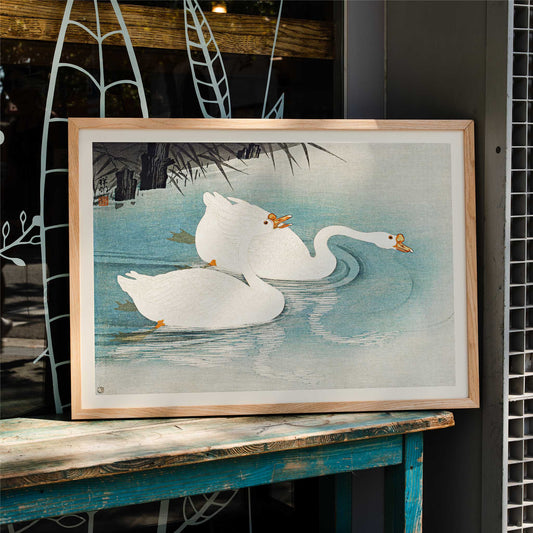 White geese swimming among blue water and reeds Geese amid Reeds by Ohara Koson poster, framed and displayed in home decor