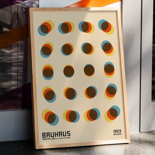 Bauhaus Poster 9 Inspired by the Weimar Exhibition with overlapping colorful circles in a geometric pattern on a beige background, framed and displayed in home decor