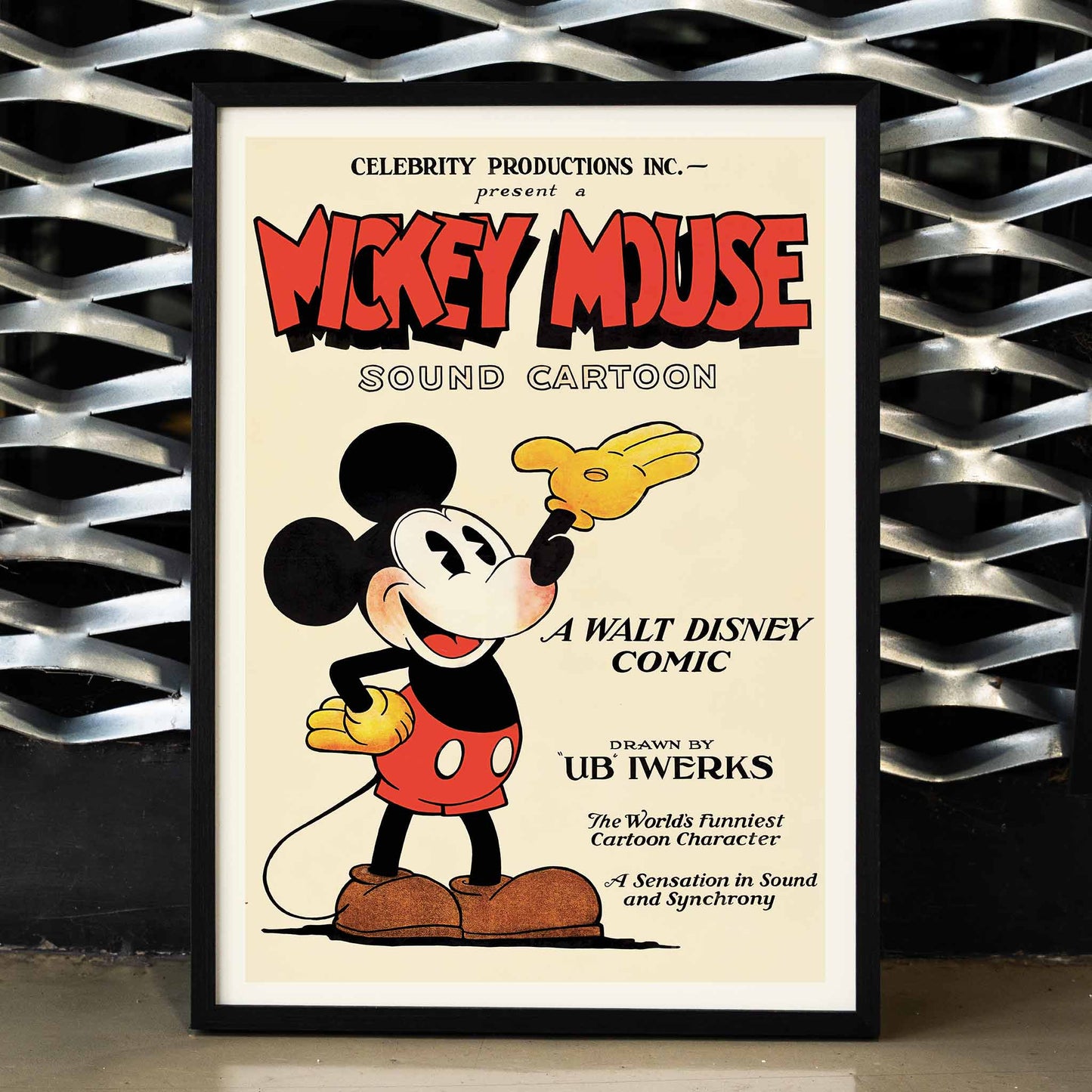 Mickey Mouse poster by Ub Iwerks and Walt Disney featuring Sound Cartoon comic artwork with Mickey smiling in yellow gloves and red shorts, framed and displayed in home decor