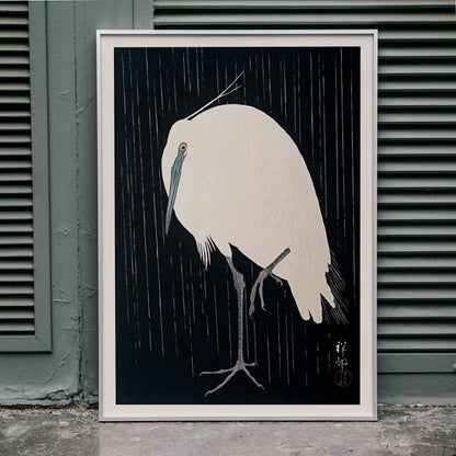 White egret standing in the rain art print poster with dark background by Ohara Koson, framed and displayed in home decor