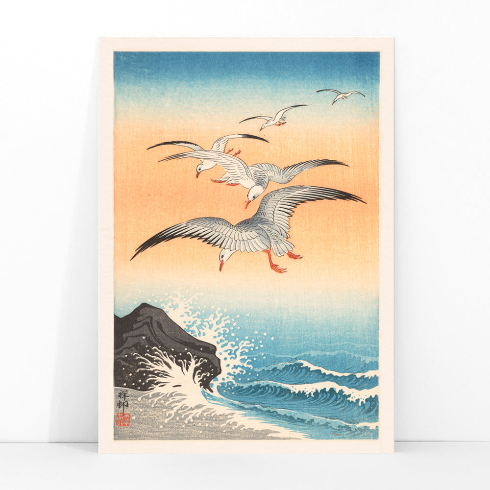 Five seagulls flying over turbulent sea with waves and rocky shore artwork by Ohara Koson, framed and displayed in modern living room decor