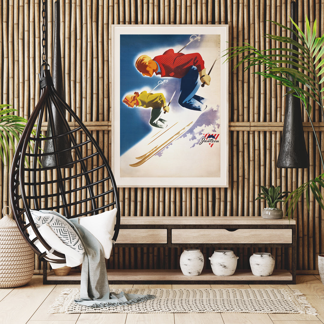 Vintage skiing poster of man and woman skiing downhill in bold colors by Joseph Binder for Jantzen, framed and displayed in home decor