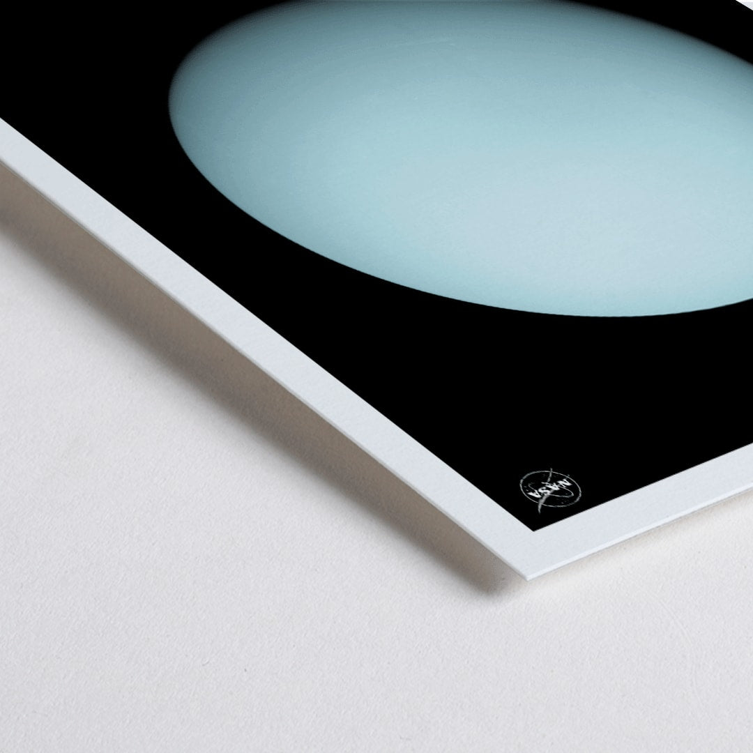 Closeup detail of NASA poster of the planet Uranus featuring a light blue sphere against a black background with the title Uranus