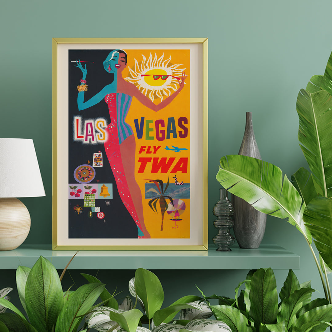 Colorful vintage Las Vegas travel poster by David Klein featuring showgirl stylish woman sun and casino imagery promoting Las Vegas fly TWA, framed and displayed in home decor
