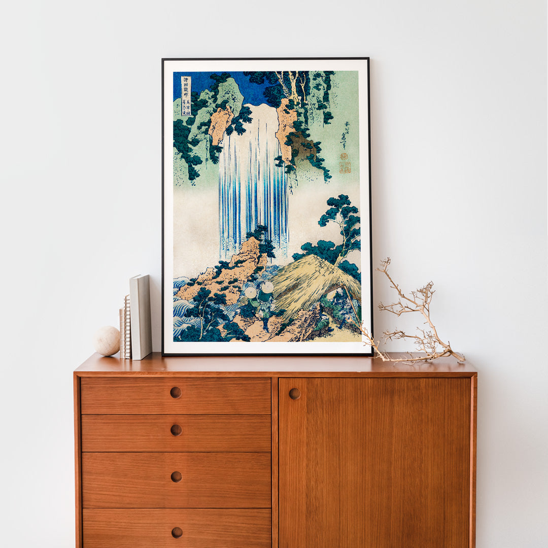 Yoro Waterfall in Mino Province by Katsushika Hokusai featuring lush greenery figures trees rocks and people in straw hats, framed and displayed in home decor