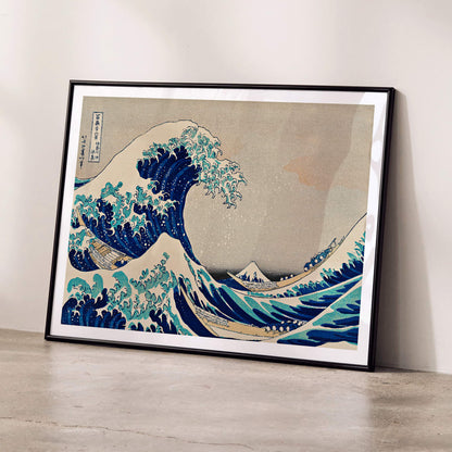 Kanazawa Oki Nami Ura by Katsushika Hokusai Japanese Ukiyo-e style poster featuring dramatic large waves boats and Mount Fuji in the background, framed and displayed in modern living room decor